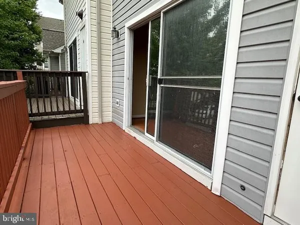 a view of outdoor space with deck and front view of a house