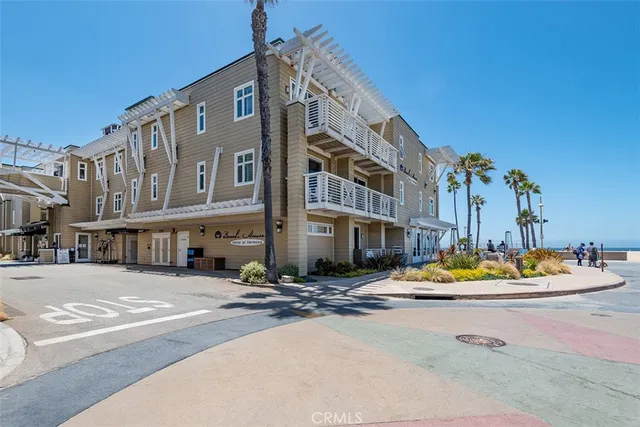 a row of palm trees in front of a building