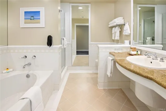 a bathroom with a tub sink and mirror
