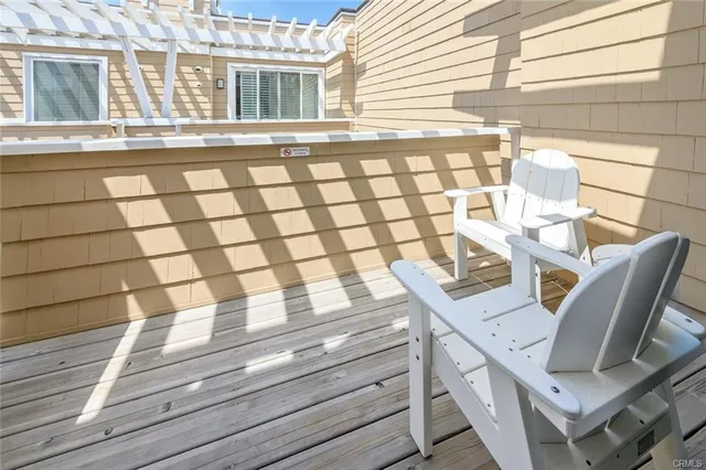 a view of a patio with table and chairs and wooden floor