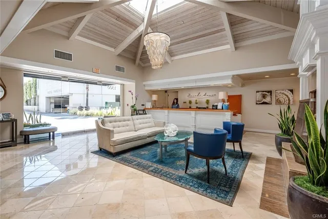 a living room with furniture and a chandelier