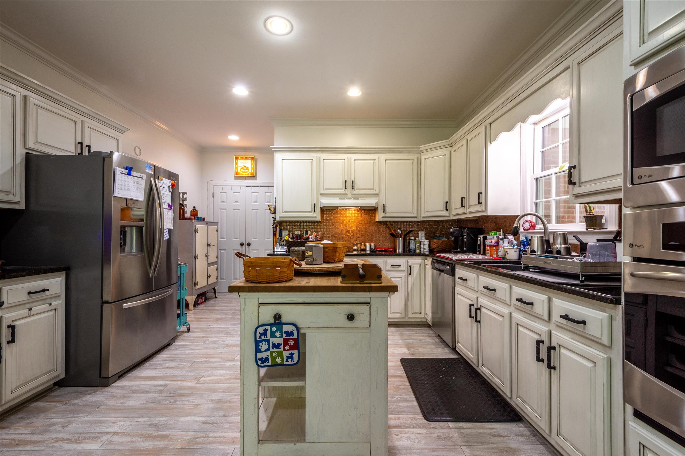 10475 Bethel Road Prospect, TN 38477 - Photo 8 of 30 a kitchen with stainless steel appliances granite countertop a refrigerator stove and sink