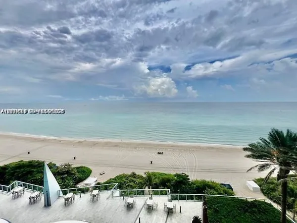 a view of a lake with beach and parking space