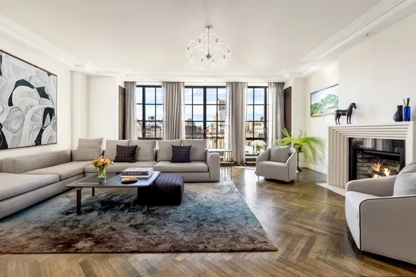 a living room with furniture fireplace and a table