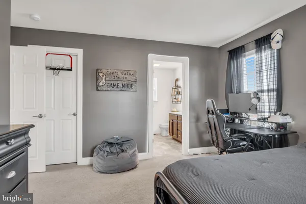 a view of a livingroom with a potted plant and empty room