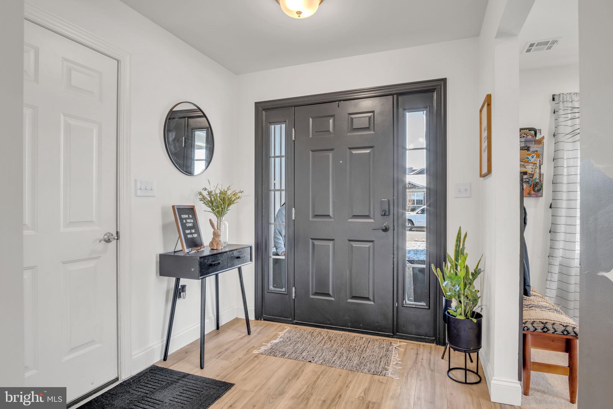 100 Eagle Road Dillsburg, PA 17019 - Photo 5 of 45 a view of a hallway that has wooden floor a table and a potted plant