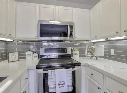 a kitchen with stainless steel appliances granite countertop a sink stove and cabinets