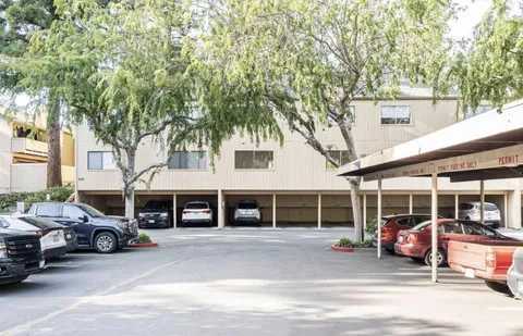 a view of a lake with large trees