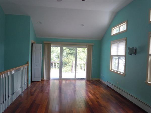 22 Lyndon Road Sharon, MA 02067 - Photo 6 of 15 a view of an empty room with wooden floor and a window