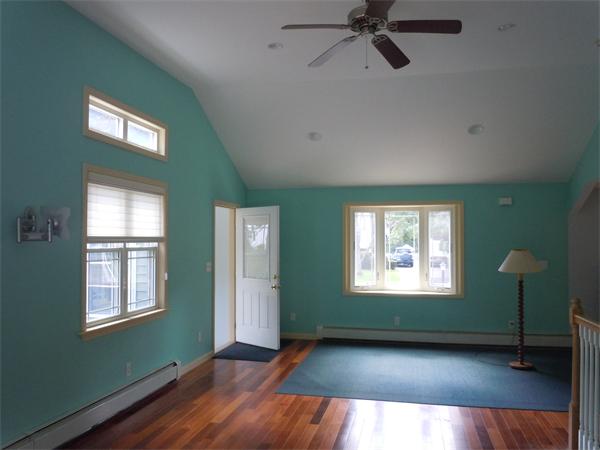 22 Lyndon Road Sharon, MA 02067 - Photo 8 of 15 a view of an empty room with a window and wooden floor