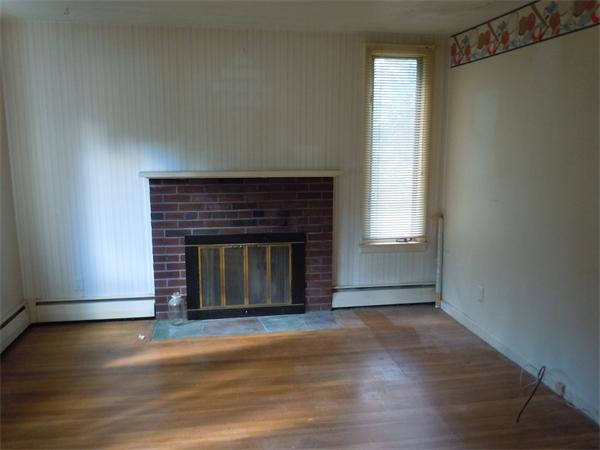 22 Lyndon Road Sharon, MA 02067 - Photo 9 of 15 a view of a livingroom with a fireplace and window