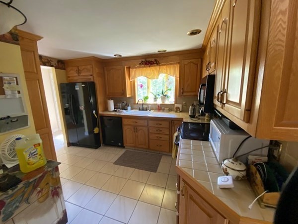 76 Woodledge Road Needham, MA 02492 - Photo 8 of 12 a kitchen with a sink appliances and cabinets