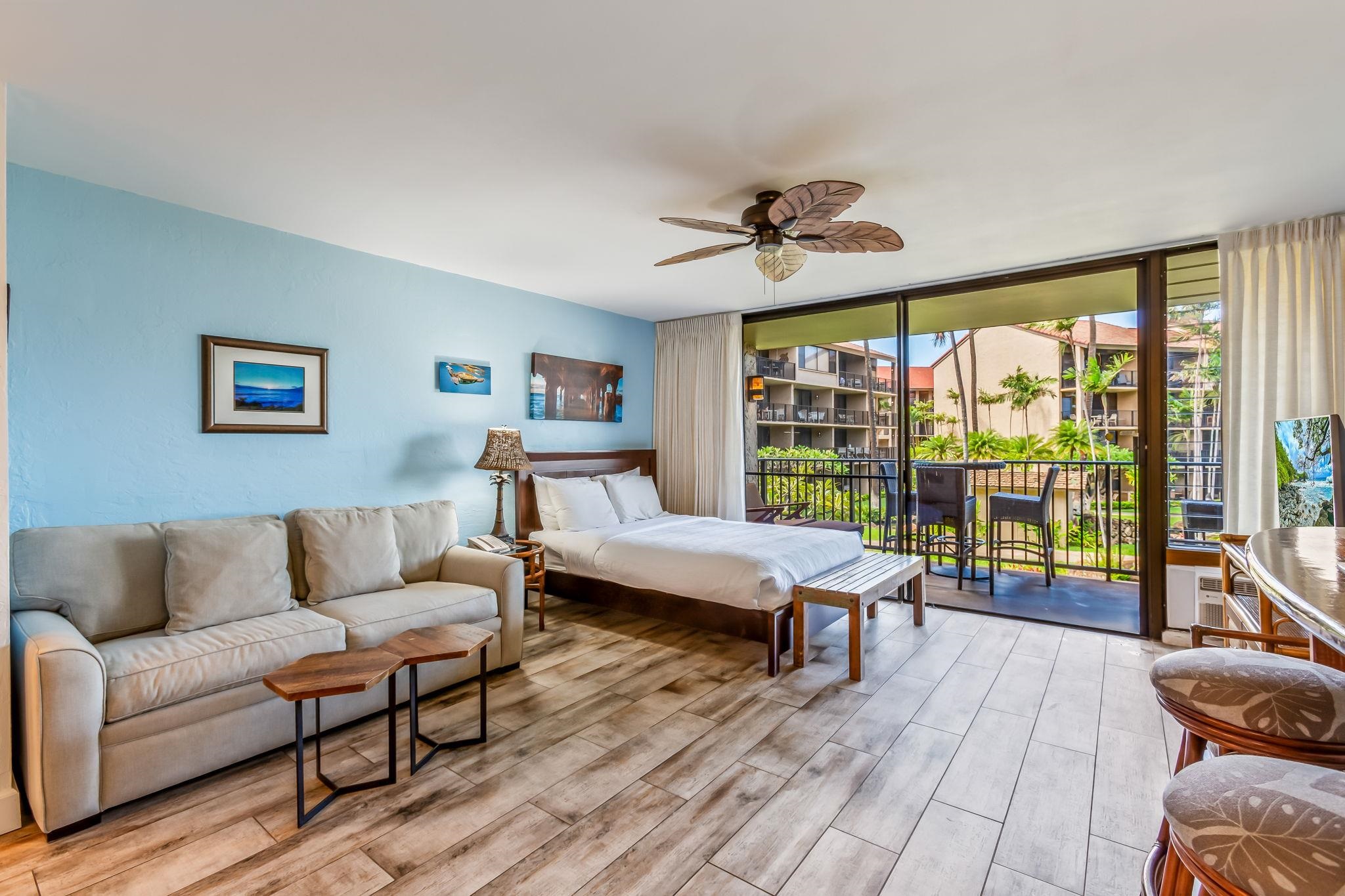 3543 Lower Honoapiilani Road, Unit C204 Lahaina, HI 96761 - Photo 12 of 28 a living room with furniture and a large window