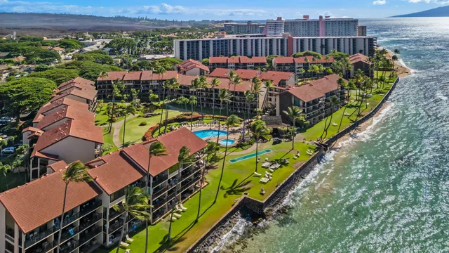 an aerial view of residential houses with outdoor space and swimming pool
