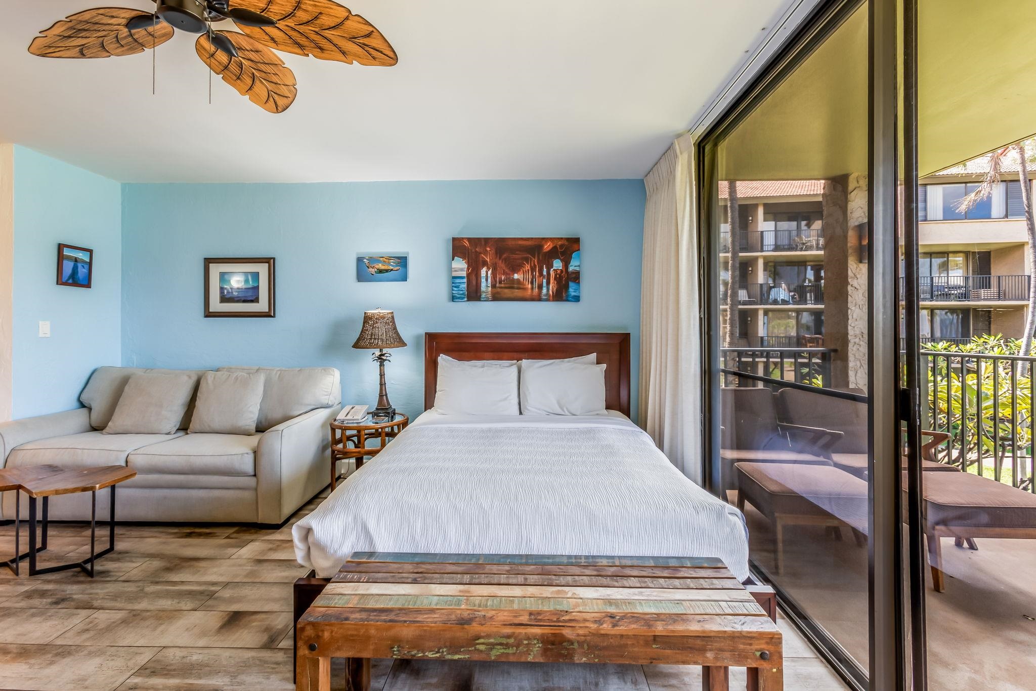 3543 Lower Honoapiilani Road, Unit C204 Lahaina, HI 96761 - Photo 5 of 28 a bedroom with a large bed and a chandelier