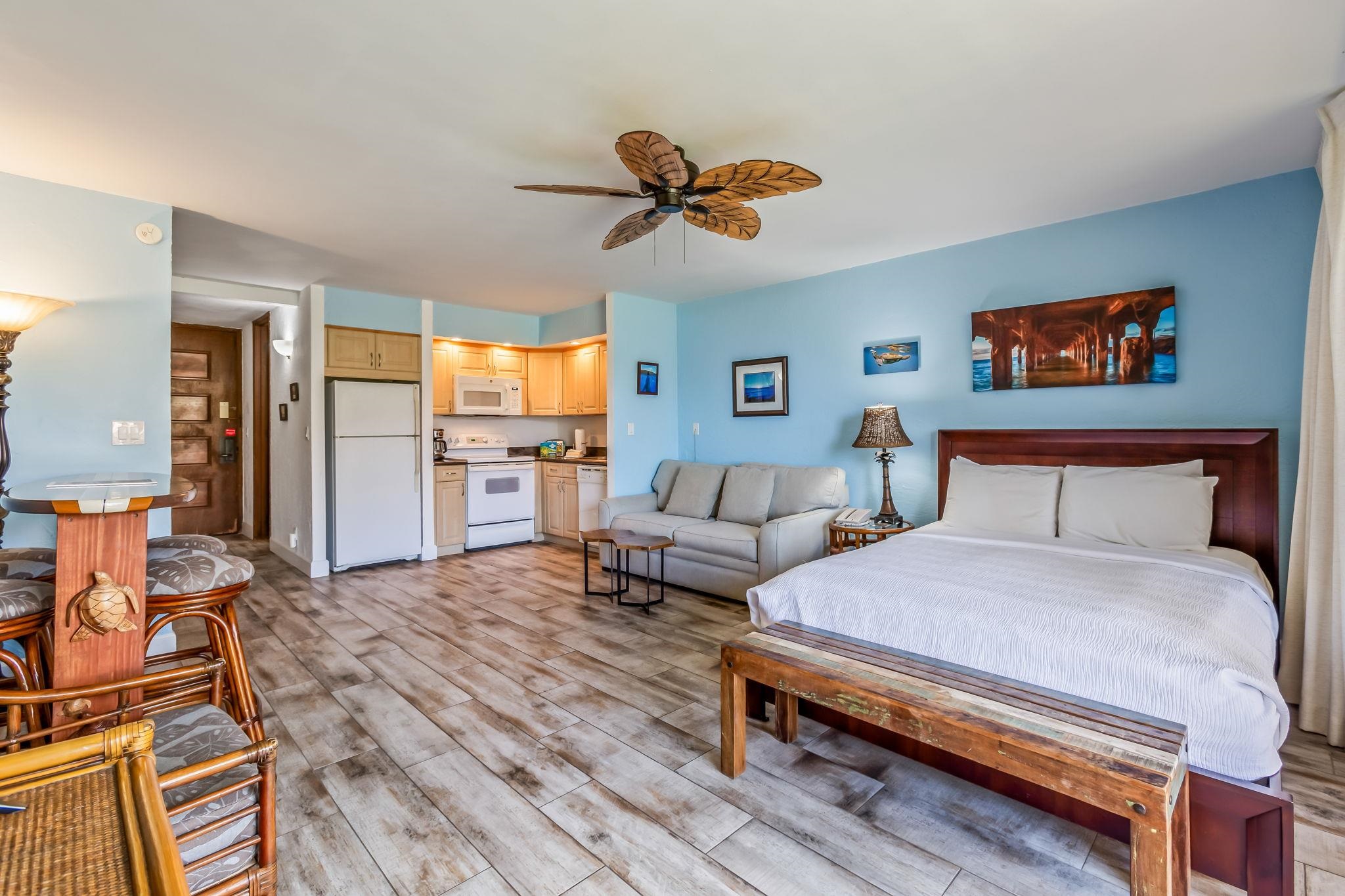 3543 Lower Honoapiilani Road, Unit C204 Lahaina, HI 96761 - Photo 6 of 28 a bedroom with a bed and a chandelier