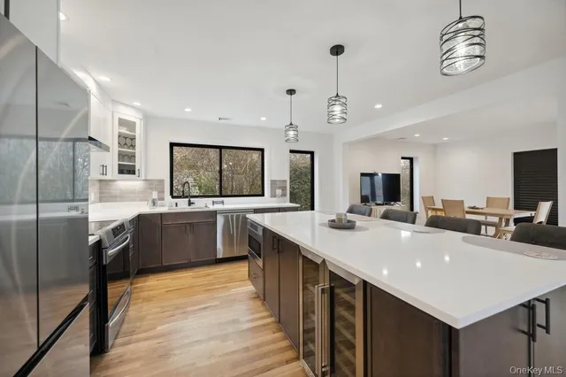 a large kitchen with a center island and stainless steel appliances