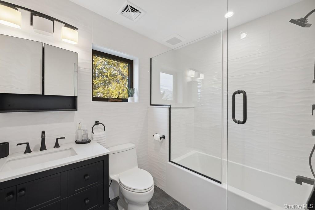 45 Ditch Plains Road Montauk, NY 11954 - Photo 10 of 19 a bathroom with a double vanity sink toilet and shower