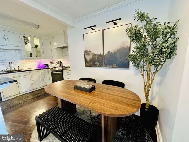 a view of a kitchen area with furniture and wooden floor