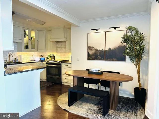 a kitchen with granite countertop a sink stove and cabinets