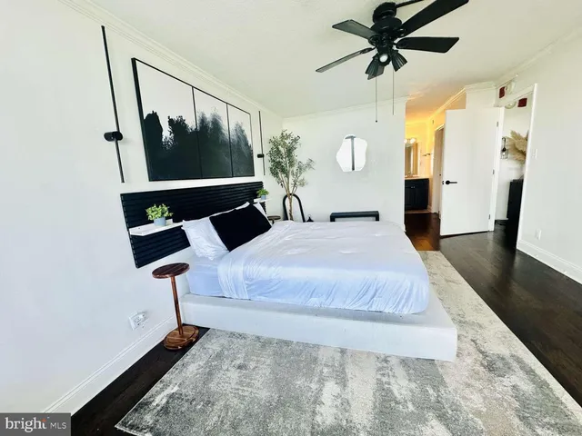 a bedroom with a bed and wooden floor