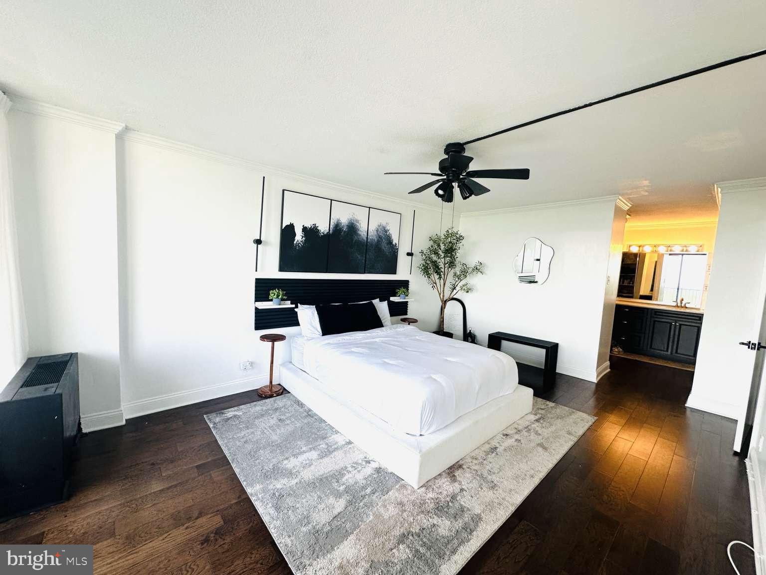 3900 West Ford Road, Unit 18K Philadelphia, PA 19131 - Photo 24 of 49 a bedroom with a bed and wooden floor