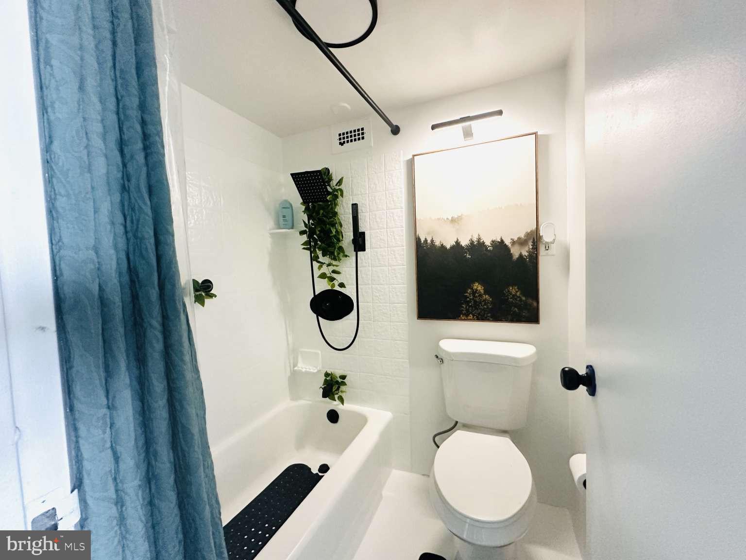 3900 West Ford Road, Unit 18K Philadelphia, PA 19131 - Photo 28 of 49 a bathroom with a toilet a sink and glass door