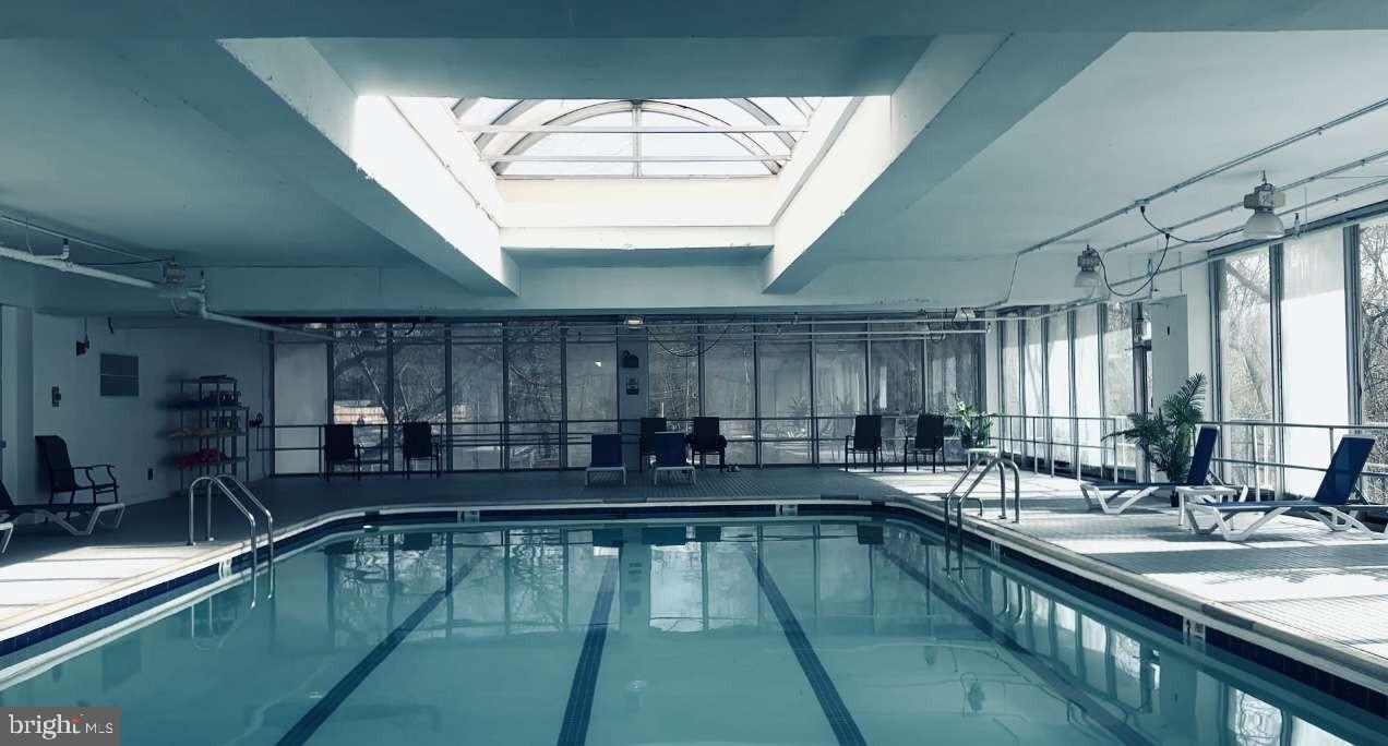 3900 West Ford Road, Unit 18K Philadelphia, PA 19131 - Photo 37 of 49 a kitchen with a large window in it and kitchen island