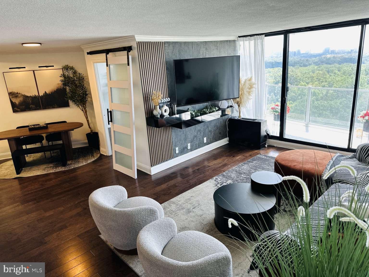 3900 West Ford Road, Unit 18K Philadelphia, PA 19131 - Photo 10 of 49 a living room with furniture and a flat screen tv