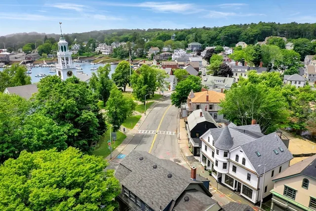 an aerial view of multiple houses with a yard