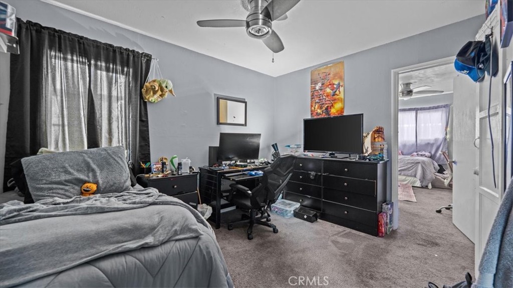 1030 North Western Avenue Colton, CA 92324 - Photo 2 of 32 a bedroom with a bed and furniture