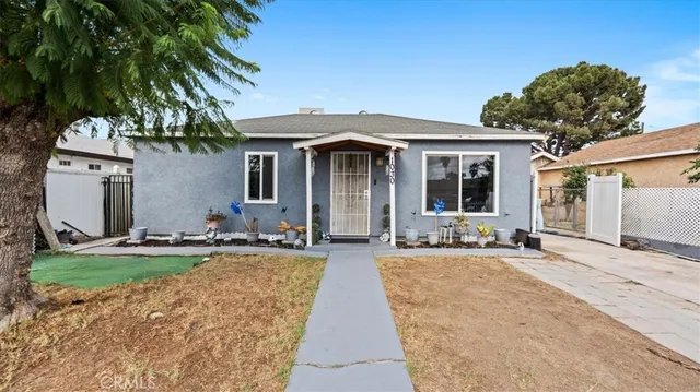 a front view of a house with yard and glass windows