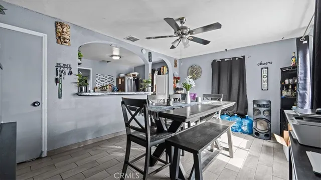 a view of a dining room with furniture and a chandelier