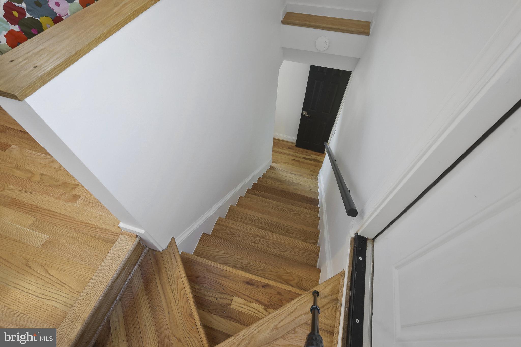 116 Commerce Street Alexandria, VA 22314 - Photo 23 of 50 Inviting staircase with warm wood tones.