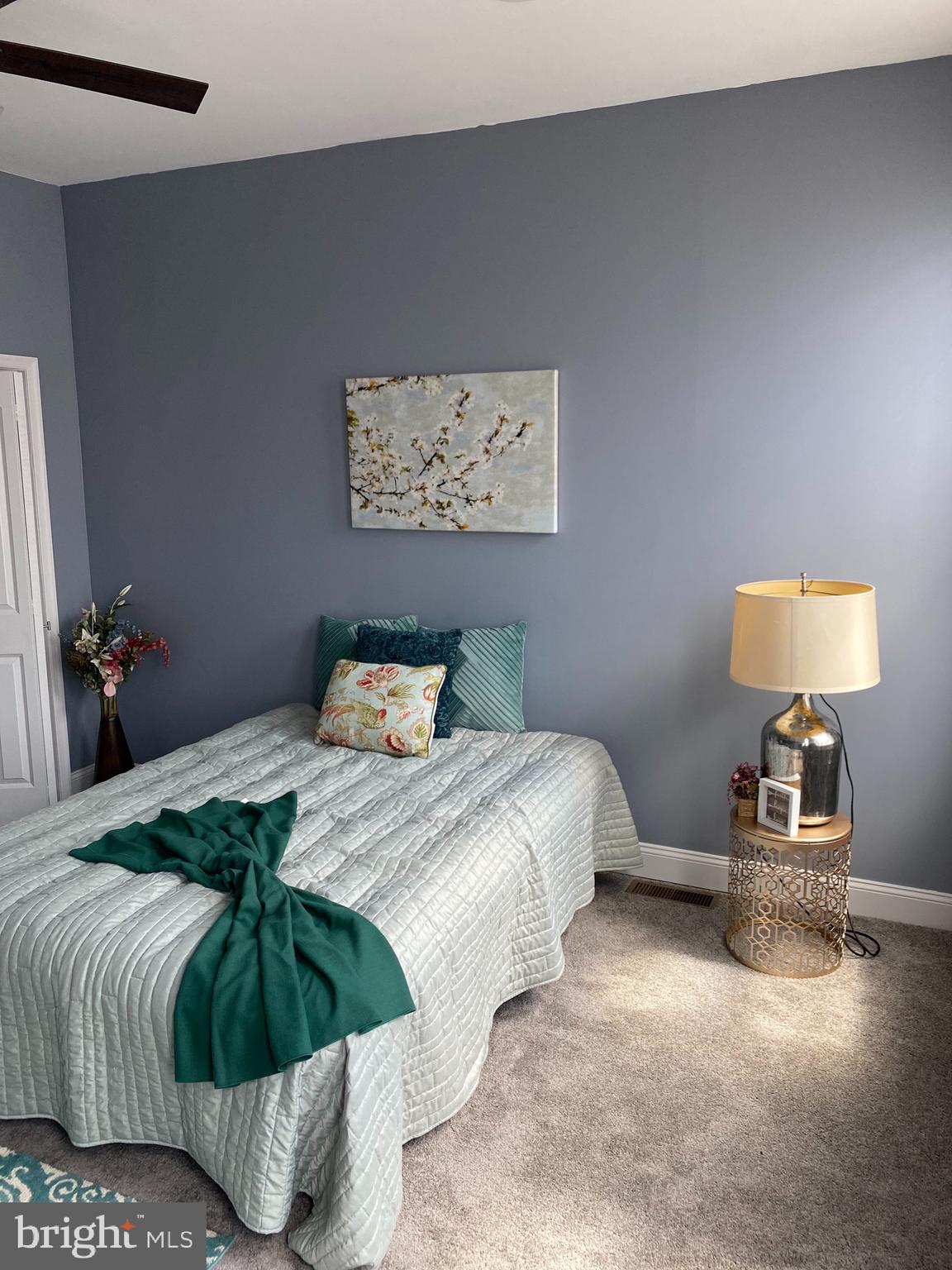 2658 Edmondson Avenue Baltimore, MD 21223 - Photo 15 of 27 a bedroom with a bed and wooden floor