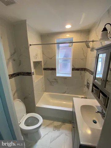 a bathroom with a sink a toilet and a bathtub
