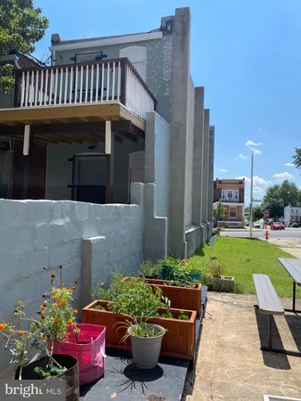 a view of a house with a yard and sitting area
