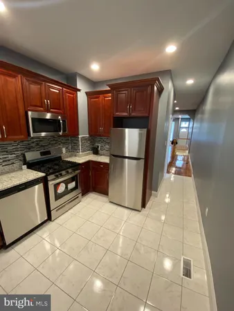 a kitchen with stainless steel appliances granite countertop a refrigerator sink and cabinets