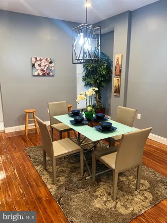 a dining room with furniture a rug and a chandelier