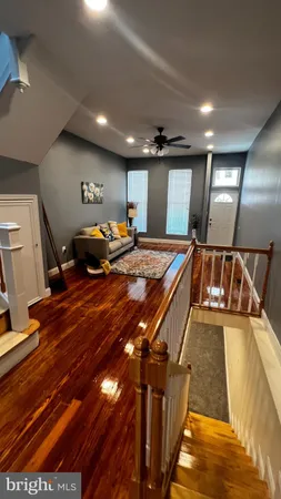 a living room with lots of furniture and mirrors