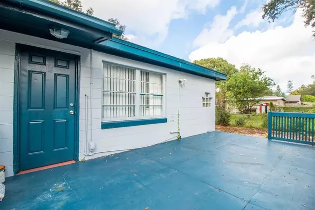 a view of an house with backyard and balcony