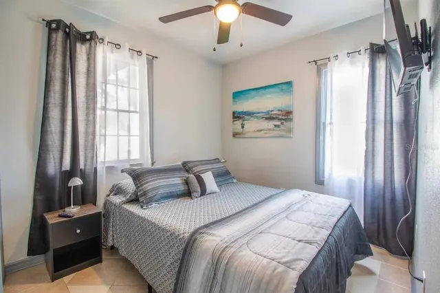 a bedroom with a large bed and a chandelier