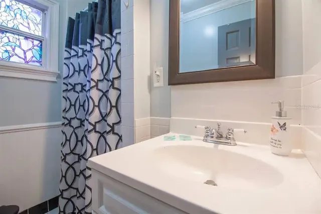 a bathroom with a sink and a mirror