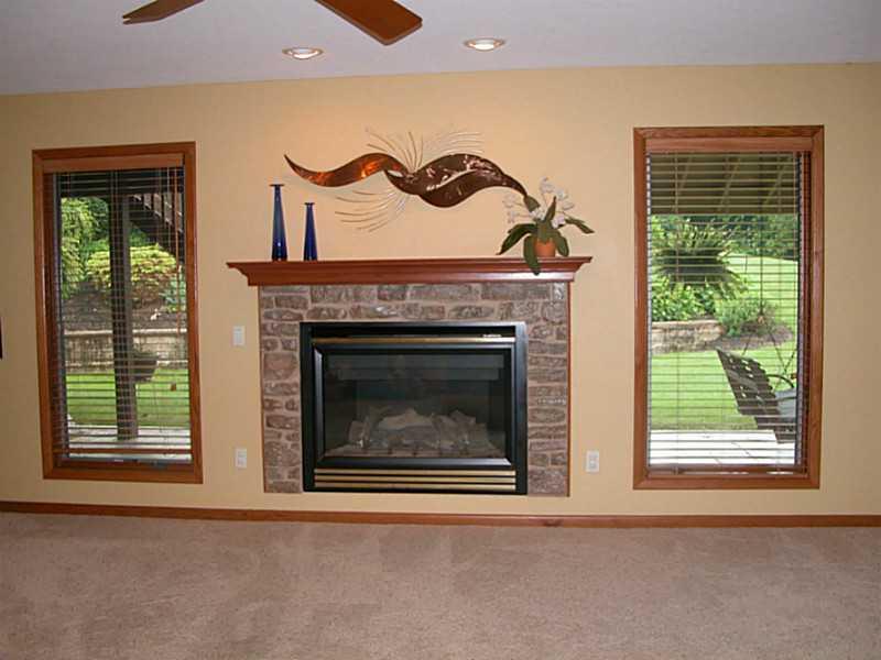 158 Scott Ridge Road Harmony, PA 16037 - Photo 12 of 25 a living room with a fireplace and a window