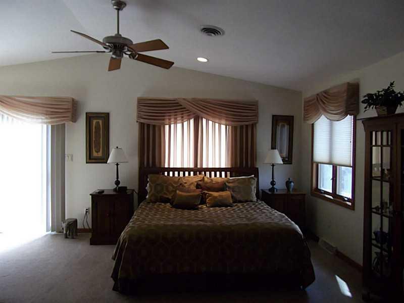 158 Scott Ridge Road Harmony, PA 16037 - Photo 15 of 25 a bedroom with a bed a window and a chandelier