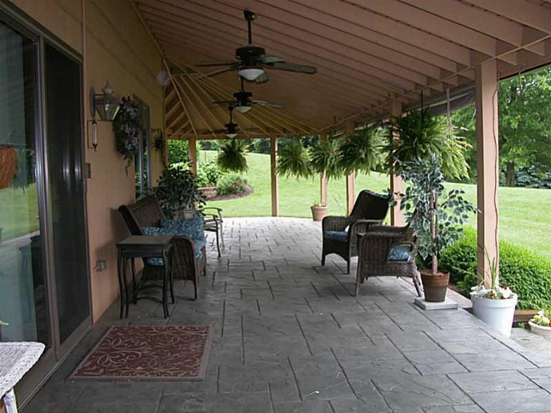 158 Scott Ridge Road Harmony, PA 16037 - Photo 3 of 25 a view of a patio with table and chairs potted plants with floor to ceiling window