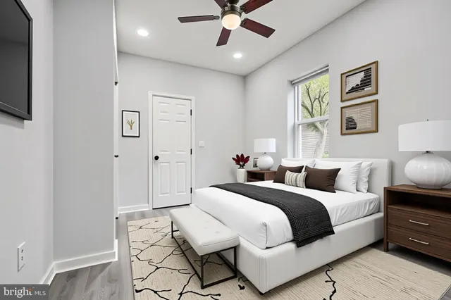 a bedroom with a large bed and a chandelier