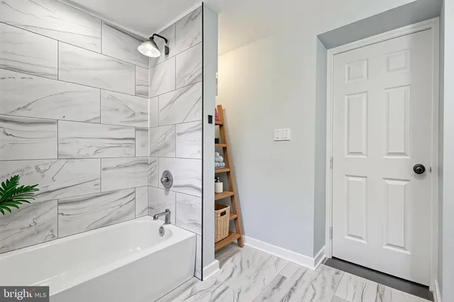 a bathroom with a bathtub and a shower