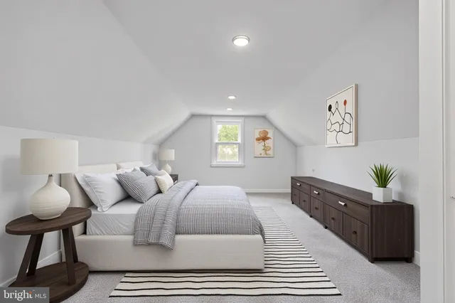 a spacious bedroom with a bed and a couch