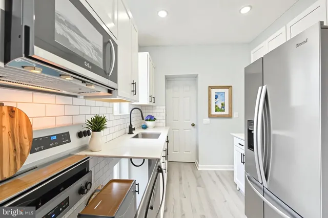 a kitchen with a refrigerator and a stove
